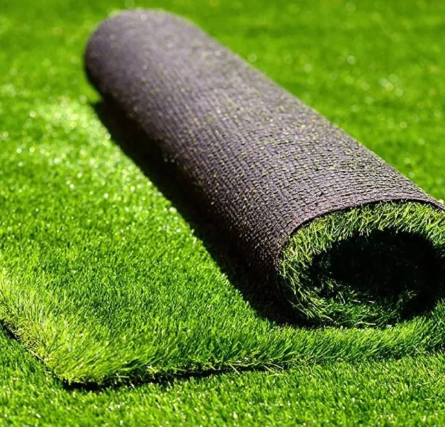 A roll of green grass on the ground.