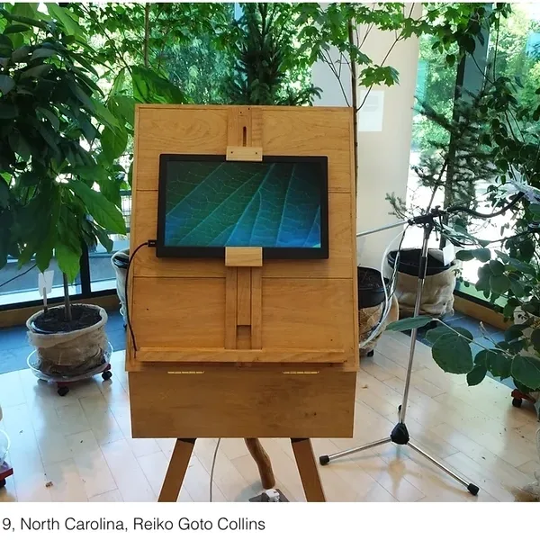 A wooden easel with a television on top of it.