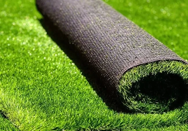 A roll of green grass on the ground.